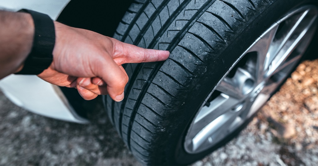 How do I check my tire tread?