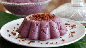 Traditional Filipino Ube Halaya served over shaved ice desserts with coconut flakes and ripe mango slices