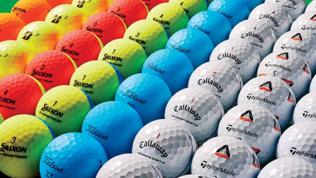 Multiple golf balls comparing compression rating golf options during a ball fitting session