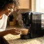 Close-up of coffee machine being descaled and maintained in a kitchen