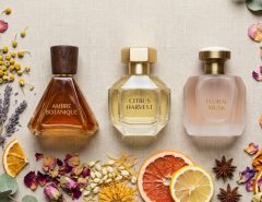 Elegant perfume bottle on a marble counter in warm sunlight.