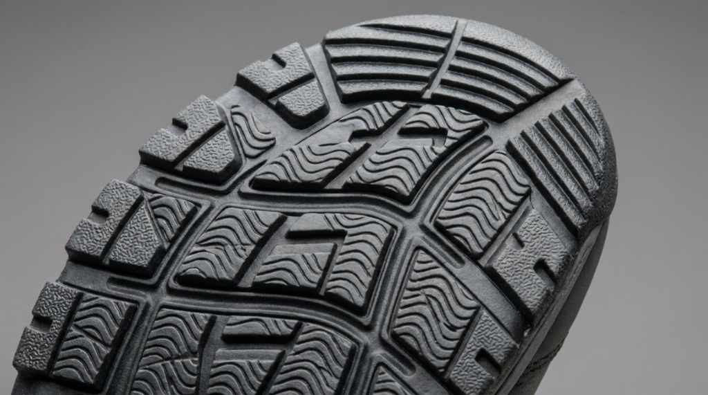 Close-up of rubber outsole traction patterns on a non-slip marine fishing shoe.