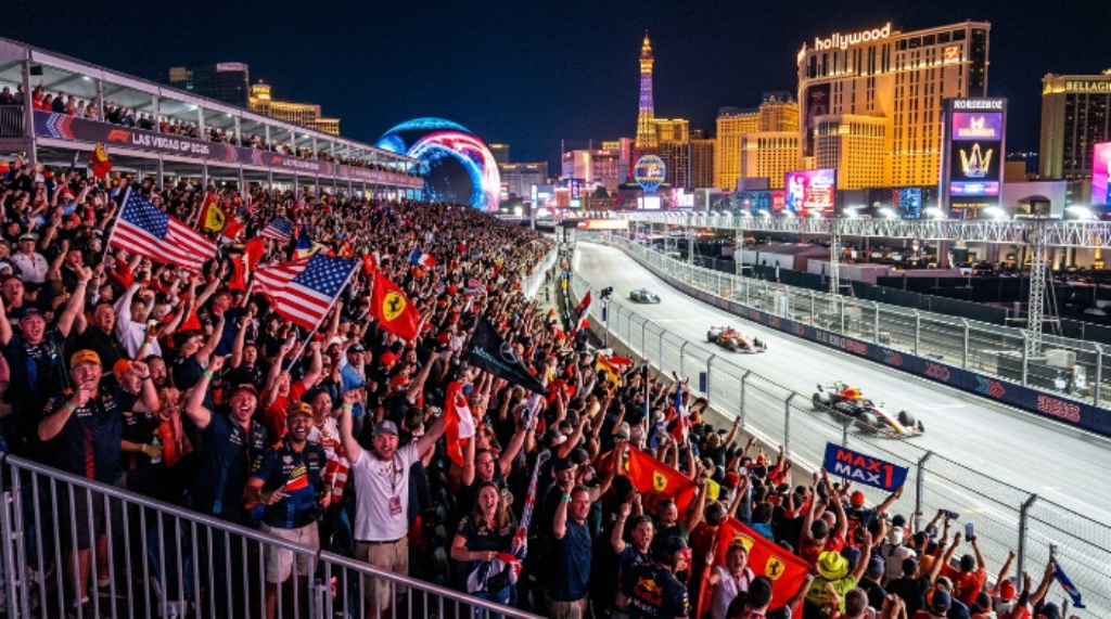 Fans cheering in packed grandstands along the Harmon Straight at the Formula 1 Las Vegas Grand Prix 2026 during the Saturday night race