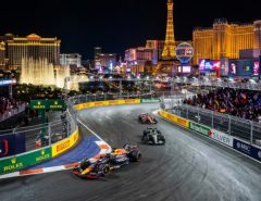Formula 1 cars racing at night past illuminated Las Vegas Strip hotels along the Las Vegas Strip Circuit during the 2026 Las Vegas Grand Prix on November 21