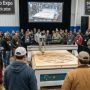 Woodworking professionals watching a live CNC router demonstration on the expo floor at Wood Pro Expo Lancaster 2026 at Spooky Nook Sports Center in Manheim, Pennsylvania