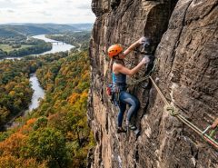 A rock climber scaling a cliff using a colorful dynamic climbing rope in Pennsylvania.