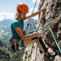 Climber inspecting a dynamic outdoor climbing rope on a sunny rock face