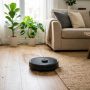 Robot vacuum mop combo cleaning a modern living room floor.