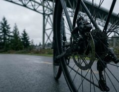 Bike rider checking dual brake dragging on Seattle path
