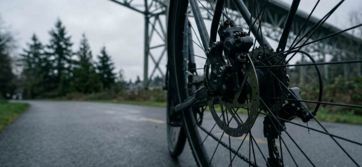 Bike rider checking dual brake dragging on Seattle path