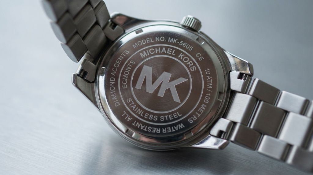 Inspecting the Michael Kors watch logo and dial details