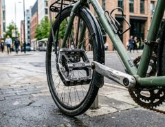 Heavy-duty metal BMX platform pedals installed on an urban commuter bike.